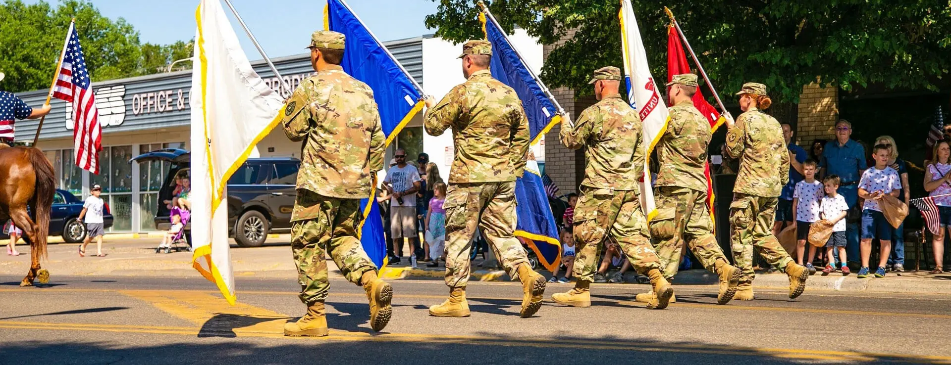 A group of soldiers marching down the street.