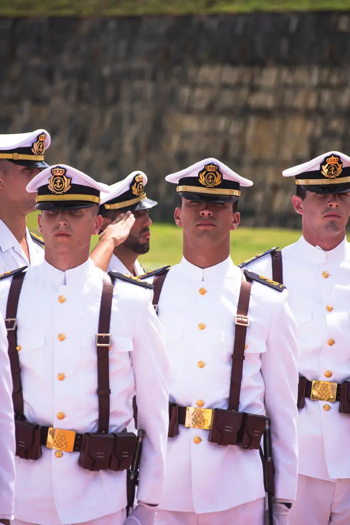 A group of men in white uniforms standing next to each other.