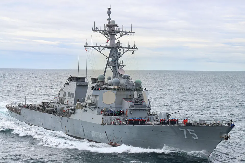 A large military ship sailing in the ocean.