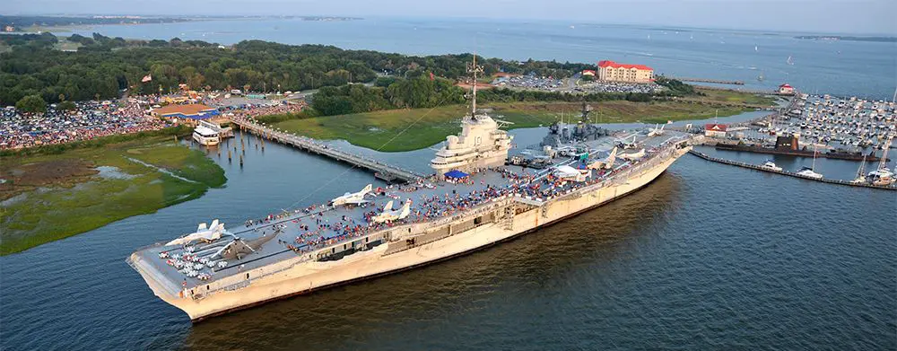 A large ship in the water with people on it.